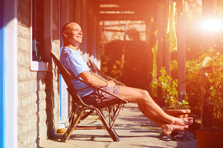 Man sitting on his clean patio enjoying the sun